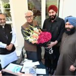 Defense Minister Khawaja Muhammad Asif receives a bouquet from a Sikh community delegation at his residence