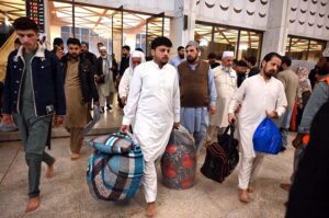 The faithful are welcomed by their relatives after completing i'tikaf and emerging from Faisal Masjid upon the sighting of the Shawwal moon