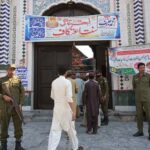 Secutity official standing alert during the third Friday prayer of Ramzan ul Mubarak outside Hamid Shah Masjid