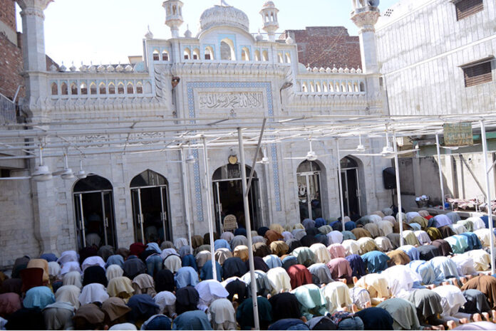 Muslim worshipers offer Juma tul Vida prayers during the holy fasting month of Ramzan in a local Mosque