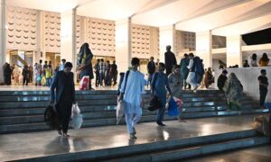 The faithful are welcomed by their relatives after completing i'tikaf and emerging from Faisal Masjid upon the sighting of the Shawwal moon