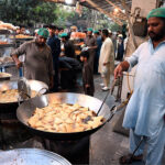 Workers busy in preparing traditional food item Samosa for frying at his workplace at I-10 markaz during Holy month of Ramzan ul Mubarak