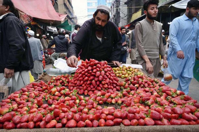 Vendor displaying strawberries to attract the customers during Iftar in the Holy Fasting month of Ramzan ul Mubarak