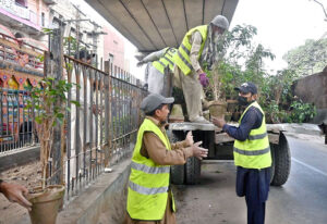 Gardeners actively plant saplings under PHA's supervision as part of the Spring Tree Plantation Campaign beneath the Data Darbar Metro Bridge.