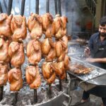 Vendor preparing traditional food item Sajji to attract the customers during the Holy Fasting month of Ramzan ul Mubarak