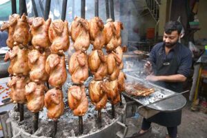 Vendor preparing traditional food item Sajji to attract the customers during the Holy Fasting month of Ramzan ul Mubarak