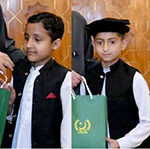 President Asif Ali Zardari distributing computer tablets among orphaned children during an Iftar Dinner hosted by him, at Aiwan-e-Sadr