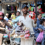 A vendor is selling home decoration items at the road side to earn for livelihood