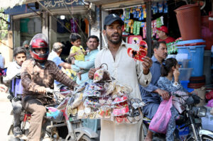 A vendor is selling home decoration items at the road side to earn for livelihood