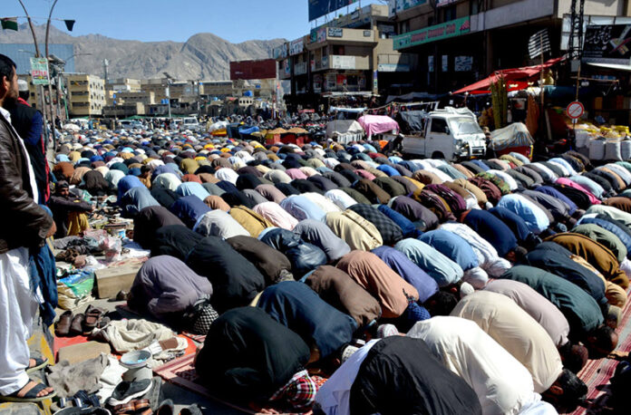 Worshipers offering prayers of last Friday in the holy month of Ramzan at Meezan Chowk
