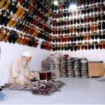 A cobbler preparing traditional shoes at his workplace in the Provincial Capital
