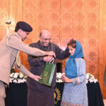 President Asif Ali Zardari distributing computer tablets among orphaned children during an Iftar Dinner hosted by him, at Aiwan-e-Sadr