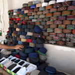 A man decorates prayer caps to attract the customers in preparation for the 27th Ramadan the last Friday prayers in the City