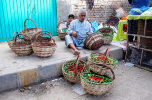 A worker preparing bird baskets at his workplace.