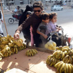 A family purchasing fruits for Iftar at Korangi area