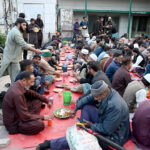 A large number of people break their fast at a free Iftar arrangement along the roadside in the holy month of Ramzan ul Mubarak at I-9 sector in the federal capital