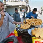A vendor is preparing sweet used in Iftar