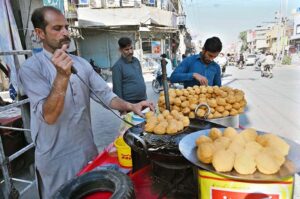 A vendor is preparing sweet used in Iftar