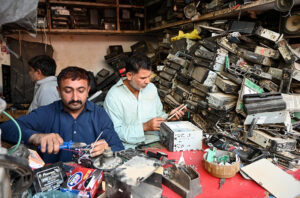 Mechanics repairing car tapes at their workplace