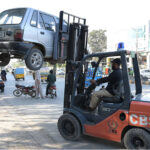 A traffic lifter removing wrong parked car at college Road