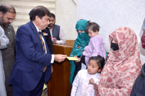 Federal Minister for Pakistan Railway Hanif Abbasi distributing cash cheques among widows of Railway employees at Quetta Railway Divisional Superintendent Office who had been martyred in Jaffar Express incident near Bolan