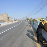 Labourers installing plant pot on new built flay over at Qanchy Moor
