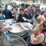 A vendor making a traditional sweet item (Jalebi) at Burns Road for iftar on the first day of holy fasting month of Ramazan