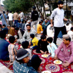 Volunteers distributing free food for iftari in front of Walton Road