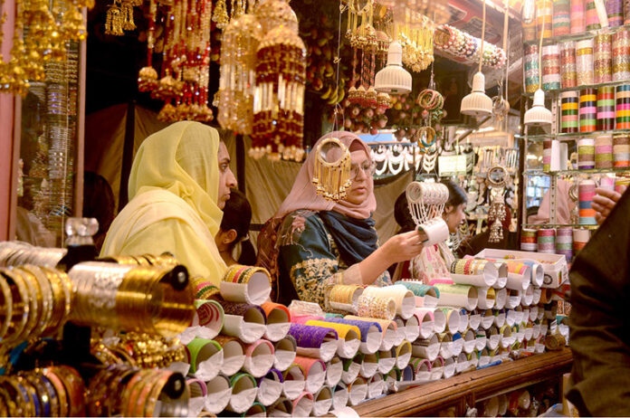 Women buying bangles at market in preparation of Eid-ul-Fitr in the City Women buying bangles at market in preparation of Eid-ul-Fitr in the City