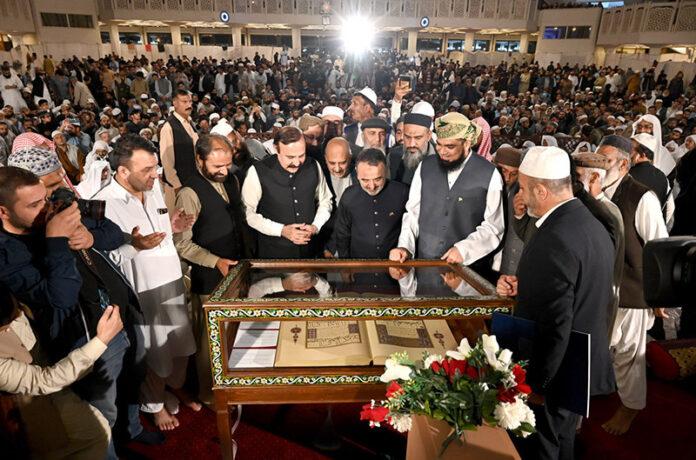Federal Minister for Parliamentary Affairs Dr. Tariq Fazal Chaudhry and Turkish Ambassador to Pakistan Irfan Neziroglu watching a historic copy of the Holy Quran gifted by Turkiye to Pakistan on display at Faisal Mosque