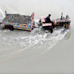 A tractor trolley loaded with river sand one of the fine sand used in concrete mixture, passing through Rice Canal