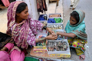 A girl selecting artificial jewelries during shopping in preparation of upcoming Eid Ul Fitr at Resham Gali