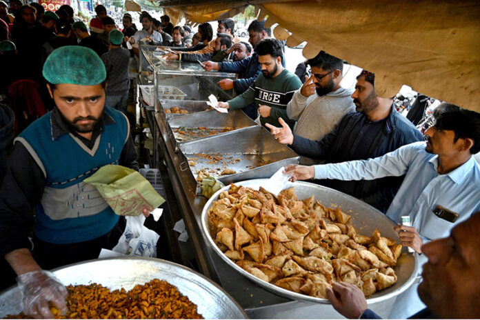 A large number of people buying food items for Iftar in the fasting month of Ramadan ul Mubarak at Blue Area