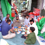 Workers breaking fast in holy Ramadan at the Tarpaulin sheet Market