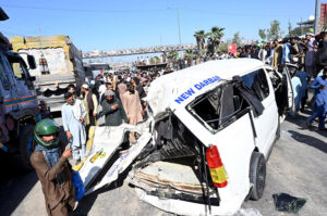 A large number of people gathered around a flip over truck collided with passenger vans due to over speed at IJP Road resulted causalities of four people on the spot
