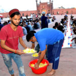 Volunteers distributing free food among the people for Iftar in Badshabad Shahi Mosque during the fasting month of Ramdan