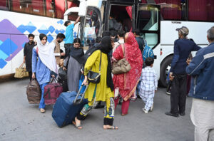 A large number of people purchasing tickets leaving for their hometowns at Faizabad Bus Stand to celebrate Eid ul fitr festive with their loved ones