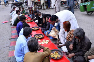 Volunteer of Saylani Welfare distributes sweet drink among people in fast during Iftar in the fasting month of Ramadan at Risala Road.