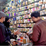 A woman selecting bangles at a shop in Dharmapura Bazaar in preparation of the upcoming Eid al-Fitr