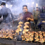 A volunteer making green chicken tikka Mandi for Grant 'Sehri' on the holy fasting month of Ramzan ul Mubarak free meal arranged by JDC Foundation Pakistan at Numaish Chowrangi