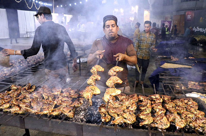 A volunteer making green chicken tikka Mandi for Grant 'Sehri' on the holy fasting month of Ramzan ul Mubarak free meal arranged by JDC Foundation Pakistan at Numaish Chowrangi