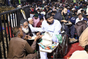 Volunteers serve food to the families at 'Sehri' during the holy fasting month of Ramzan ul Mubarak free meal distribution arranged by JDC Foundation Pakistan at Numaish Chowrangi