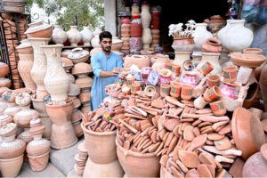 A vendor displays clay made pots at his roadside setup near Zulfiqar Bagh.