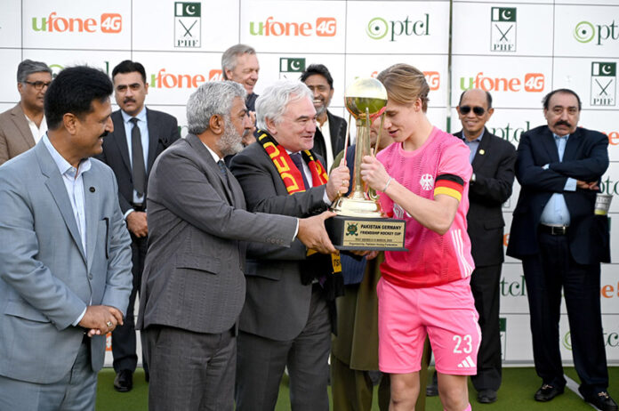 President Pakistan Hockey Federation (PHF) Tariq Hussain Bugti and German Ambassador in Pakistan Alfred Grannas present trophy to the winner team captain after final match between Germany and Pakistan Juniors Hockey teams at Naseer Bunda Hockey Stadium, Sports Complex