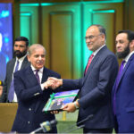 Prime Minister Muhammad Shehbaz Sharif being presented a book on one year performance of the government by Minister for Planning & Development Prof Dr Ahsan Iqbal and Minister for Information & Broadcasting Attaullah Tarar during the Special Meeting of the Cabinet at Jinnah Convention Center