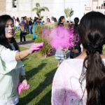 Hindu community girls celebrate the Holi festival, a vibrant Hindu Spring Festival of Colors at Mother Village Park