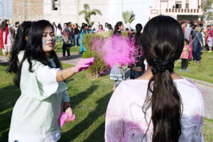 Hindu community girls celebrate the Holi festival, a vibrant Hindu Spring Festival of Colors at Mother Village Park
