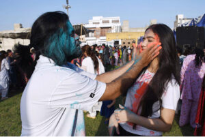 Hindu community girls celebrate the Holi festival, a vibrant Hindu Spring Festival of Colors at Mother Village Park