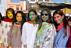 Hindu community girls celebrate the Holi festival, a vibrant Hindu Spring Festival of Colors at Mother Village Park