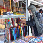 An aged man looking for Tasbih at Meezan Chowk